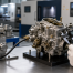 A carburetor undergoing dimensional and flow quality inspection in a modern factory